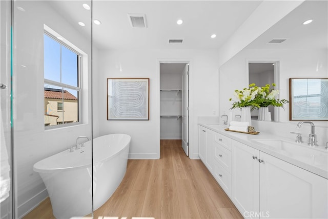270 Maricopa, Irvine, CA 92618 - full bath featuring a freestanding bath, wood finished floors, recessed lighting, double vanity, and baseboards