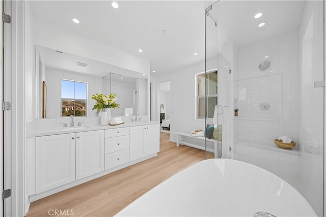 270 Maricopa, Irvine, CA 92618 - bathroom featuring a shower stall, wood finished floors, a freestanding tub, double vanity, and recessed lighting