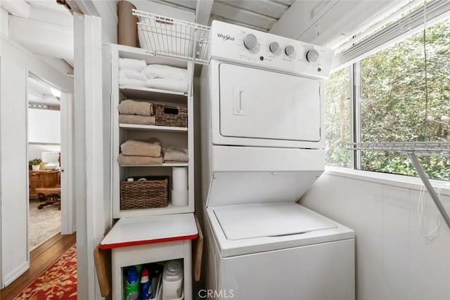 1359 Berwick Dr, Cambria, CA 93428 - laundry area featuring stacked washer / dryer, healthy amount of natural light, and wood finished floors