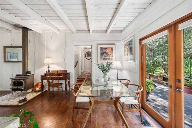 1359 Berwick Dr, Cambria, CA 93428 - dining area featuring a wood stove, wood-type flooring, beam ceiling, and french doors