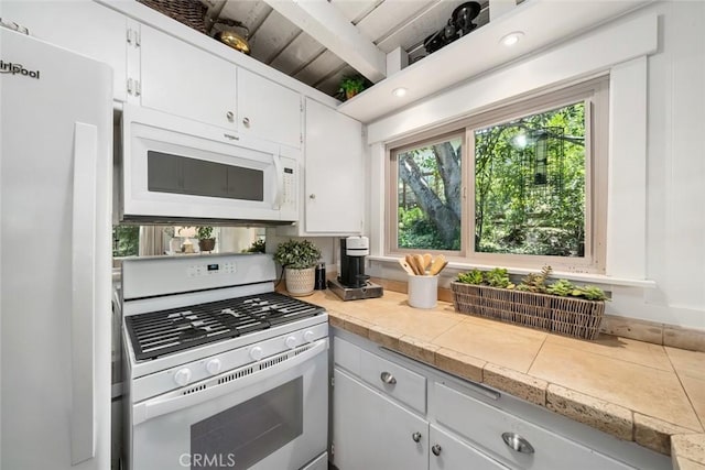 1359 Berwick Dr, Cambria, CA 93428 - kitchen with white appliances, light countertops, and white cabinetry