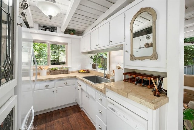 1359 Berwick Dr, Cambria, CA 93428 - kitchen featuring a sink, dishwasher, beam ceiling, light countertops, and white cabinetry