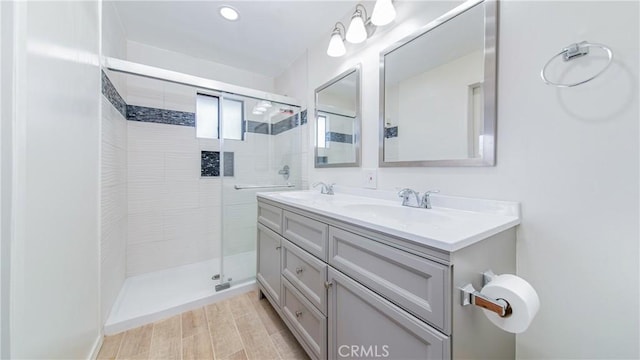7948 Glenties Way, Sunland, CA 91040 - bathroom featuring a stall shower, double vanity, recessed lighting, and wood finished floors