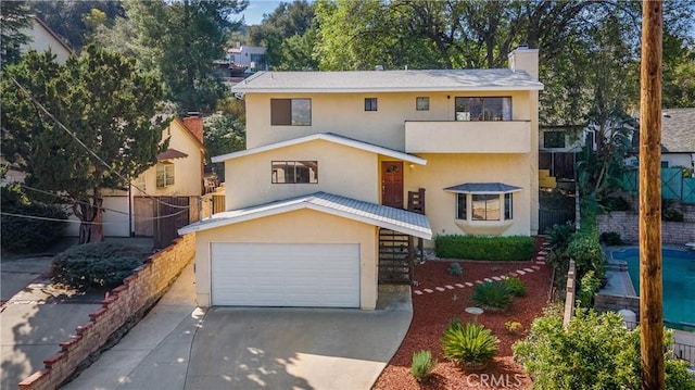 7948 Glenties Way, Sunland, CA 91040 - view of front of home featuring stucco siding, concrete driveway, a garage, and a chimney