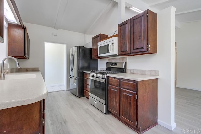 5019 Havenwood Ave, San Diego, CA 92120 - kitchen featuring appliances with stainless steel finishes, a sink, light wood finished floors, light countertops, and baseboards