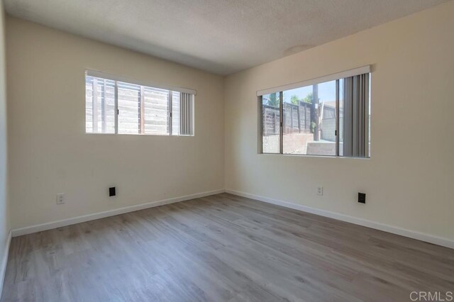 5019 Havenwood Ave, San Diego, CA 92120 - unfurnished room featuring wood finished floors and baseboards