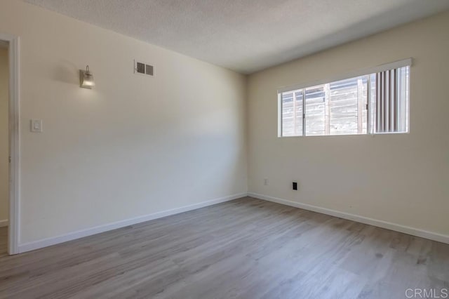 5019 Havenwood Ave, San Diego, CA 92120 - empty room featuring wood finished floors, baseboards, and a textured ceiling