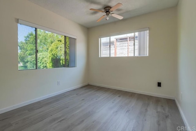 5019 Havenwood Ave, San Diego, CA 92120 - unfurnished room with a ceiling fan, wood finished floors, baseboards, and a textured ceiling