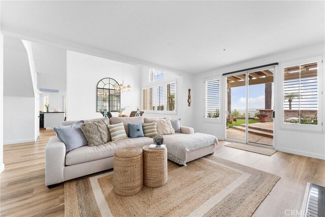 64 Camino, San Jose, San Clemente, CA 92672 - living room with a chandelier, light wood-style flooring, and baseboards