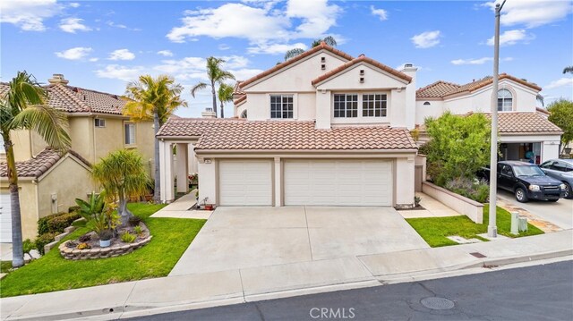 64 Camino, San Jose, San Clemente, CA 92672 - mediterranean / spanish house with a tile roof, concrete driveway, stucco siding, and a garage
