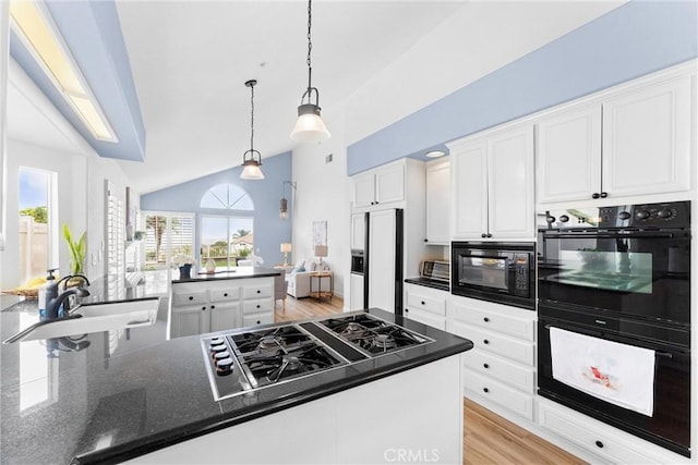 64 Camino, San Jose, San Clemente, CA 92672 - kitchen featuring black appliances, a sink, vaulted ceiling, white cabinetry, and light wood-style flooring