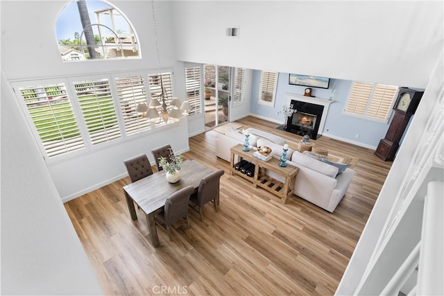 64 Camino, San Jose, San Clemente, CA 92672 - living room with plenty of natural light, a towering ceiling, wood finished floors, baseboards, and a fireplace with flush hearth