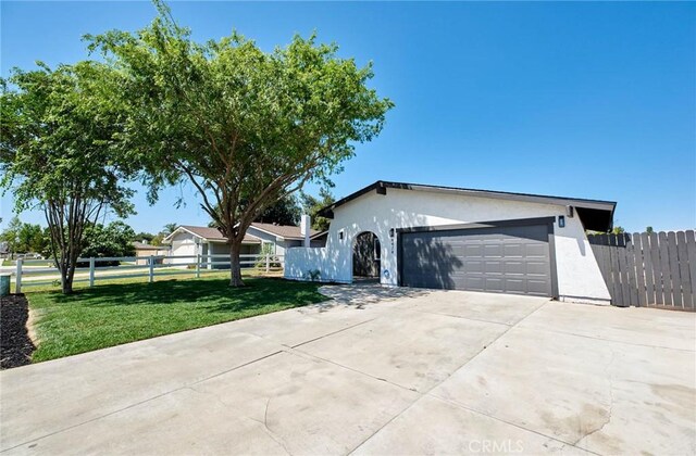 4474 Bartel Dr, Riverside, CA 92503 - ranch-style house featuring stucco siding, an attached garage, and driveway