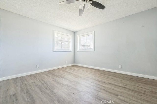 1561 Old Woman Springs Rd, Yucca Valley, CA 92284 - unfurnished room with a ceiling fan, wood finished floors, a textured ceiling, and baseboards
