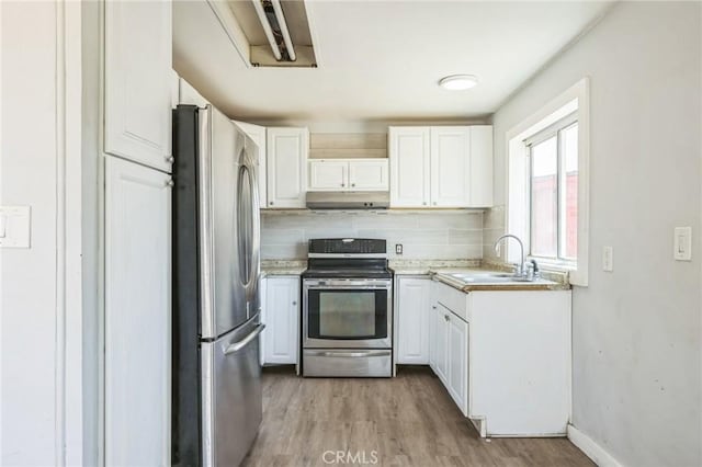 1561 Old Woman Springs Rd, Yucca Valley, CA 92284 - kitchen featuring stainless steel appliances, a sink, under cabinet range hood, white cabinetry, and light wood finished floors