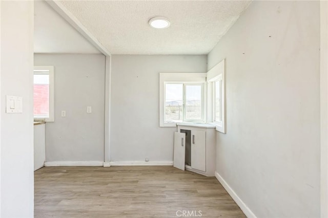 1561 Old Woman Springs Rd, Yucca Valley, CA 92284 - spare room with light wood-type flooring, a textured ceiling, and baseboards