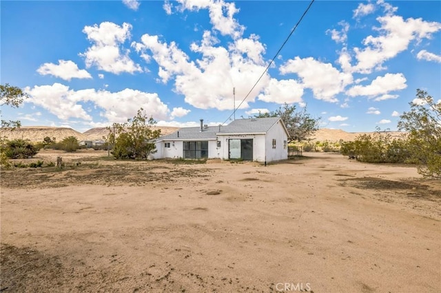 1561 Old Woman Springs Rd, Yucca Valley, CA 92284 - rear view of house featuring a view of rural / pastoral area