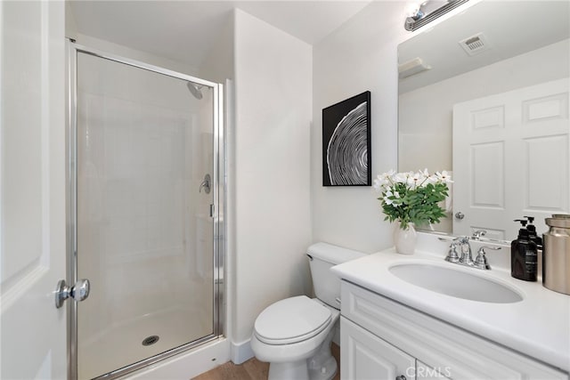 full bath featuring a shower stall, toilet, and vanity