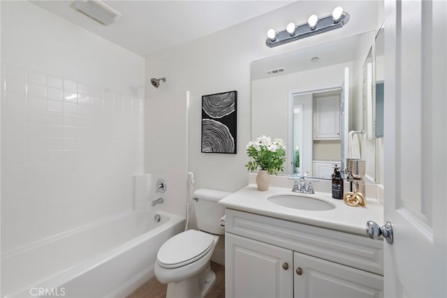 bathroom featuring toilet,  shower combination, and vanity