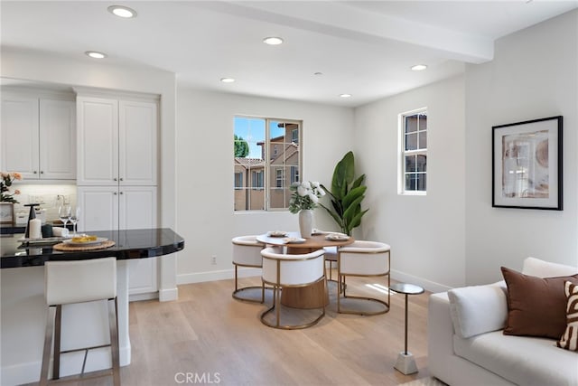 dining space with light wood finished floors, baseboards, and recessed lighting