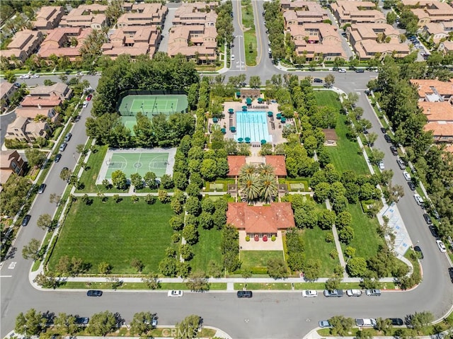 aerial view of property's location with a pool area and nearby suburban area