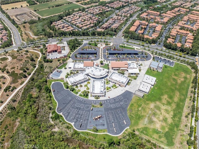 aerial view of property and surrounding area featuring nearby suburban area