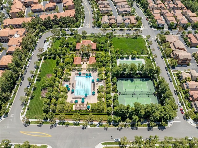 aerial view of property's location with nearby suburban area and a pool