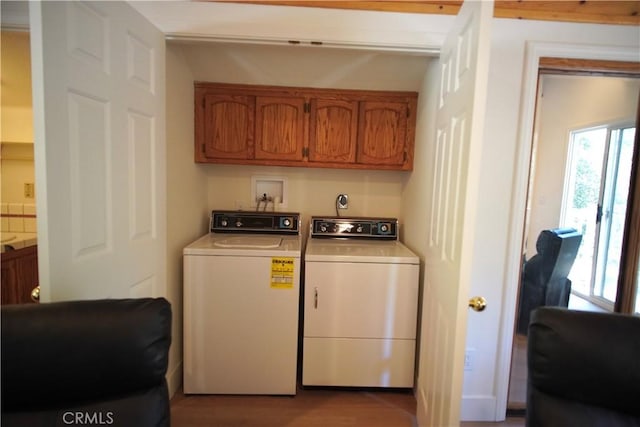 319 Dorn Dr, Crestline, CA 92325 - laundry area with washing machine and dryer, plenty of natural light, cabinet space, and wood finished floors