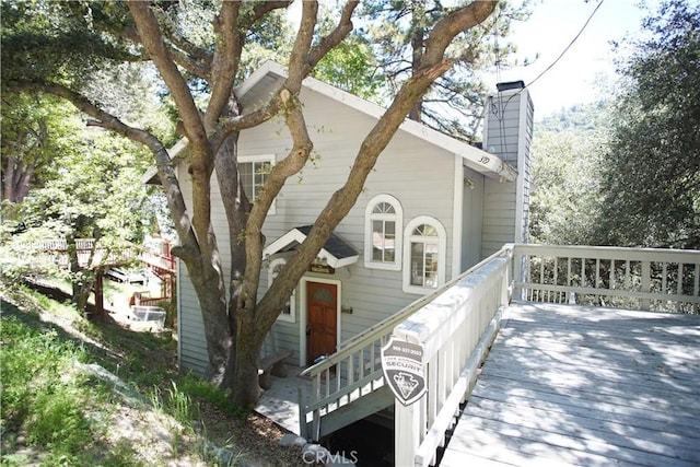 319 Dorn Dr, Crestline, CA 92325 - view of front of house featuring a deck and a chimney