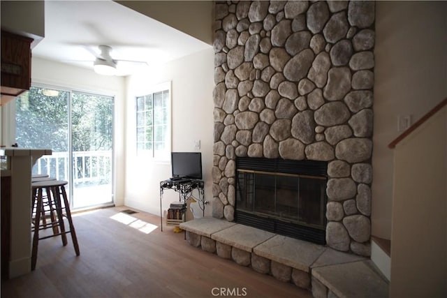 319 Dorn Dr, Crestline, CA 92325 - living area featuring ceiling fan, a stone fireplace, and wood finished floors