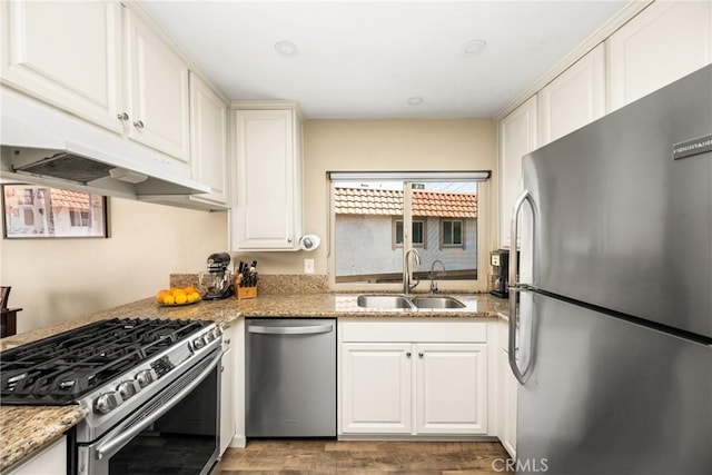 25388 Via Verde Unit 4, Lake Forest, CA 92630 - kitchen featuring appliances with stainless steel finishes, a sink, under cabinet range hood, white cabinets, and wood finished floors