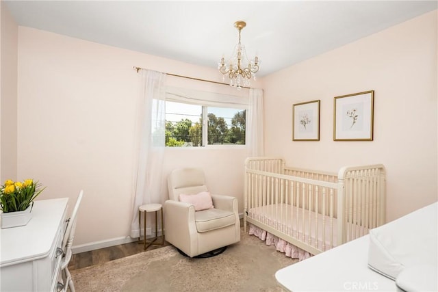 25388 Via Verde Unit 4, Lake Forest, CA 92630 - bedroom featuring wood finished floors, a chandelier, a crib, and baseboards