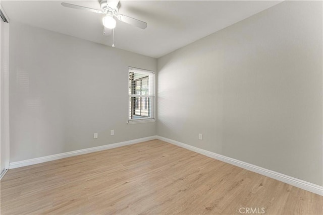 empty room with light wood finished floors, baseboards, and ceiling fan