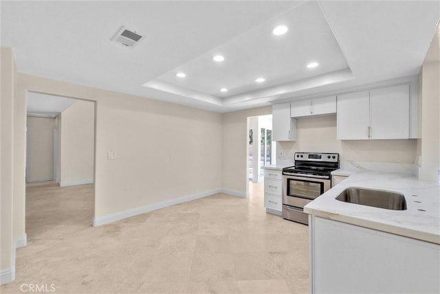 25101 Sebastian Ln, Mission Viejo, CA 92691 - kitchen with stainless steel range with electric cooktop, a raised ceiling, recessed lighting, a sink, and white cabinetry