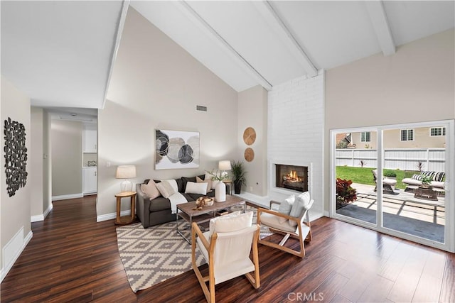 13041 Ranchwood Rd, Tustin, CA 92782 - living area with high vaulted ceiling, beam ceiling, dark wood-style floors, a brick fireplace, and baseboards