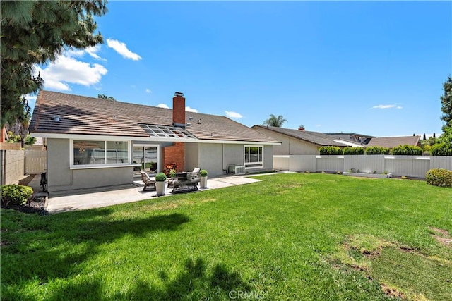13041 Ranchwood Rd, Tustin, CA 92782 - rear view of house featuring a chimney, a patio, stucco siding, and a tile roof