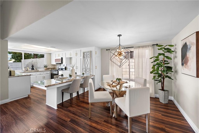 13041 Ranchwood Rd, Tustin, CA 92782 - dining space featuring a chandelier, dark wood-style flooring, and baseboards