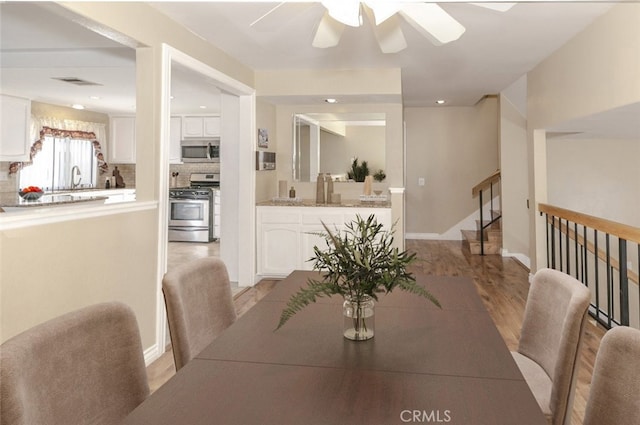 20737 Roscoe Blvd Unit 102, Winnetka, CA 91306 - dining space featuring light wood finished floors, ceiling fan, stairs, recessed lighting, and baseboards