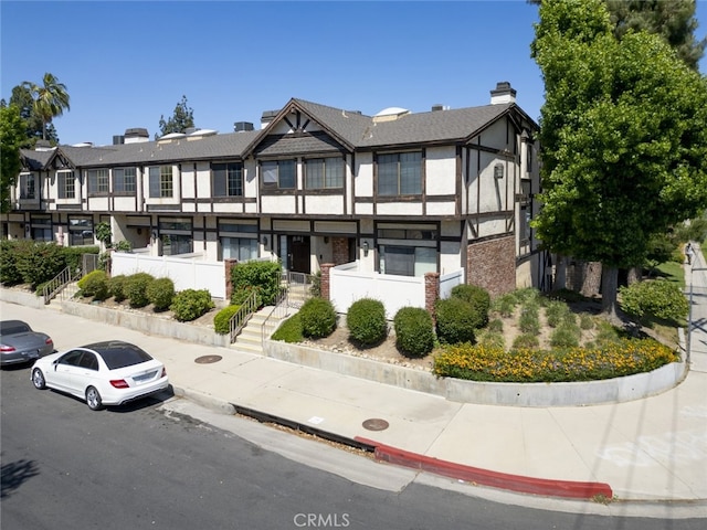 20737 Roscoe Blvd Unit 102, Winnetka, CA 91306 - view of front of property featuring stucco siding, a residential view, and stairway