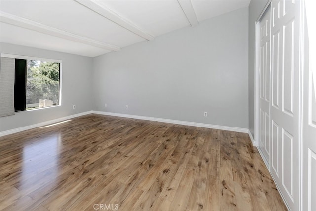 20737 Roscoe Blvd Unit 102, Winnetka, CA 91306 - unfurnished room with beam ceiling, wood finished floors, and baseboards