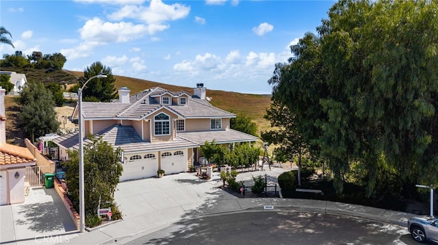 24449 Nan Ct, Diamond Bar, CA 91765 - view of front facade with an attached garage, a chimney, concrete driveway, and a tiled roof