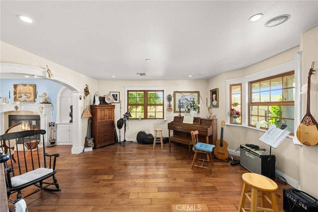 24449 Nan Ct, Diamond Bar, CA 91765 - sitting room featuring arched walkways, hardwood / wood-style flooring, recessed lighting, a glass covered fireplace, and baseboards
