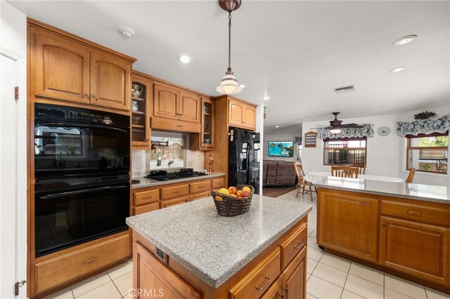24449 Nan Ct, Diamond Bar, CA 91765 - kitchen with black appliances, brown cabinetry, ceiling fan, light tile patterned floors, and glass insert cabinets