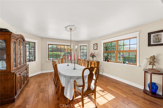 24449 Nan Ct, Diamond Bar, CA 91765 - dining room featuring baseboards, light wood-style floors, and a chandelier