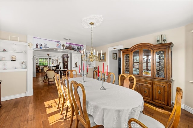24449 Nan Ct, Diamond Bar, CA 91765 - dining room with a chandelier, wood finished floors, arched walkways, and baseboards