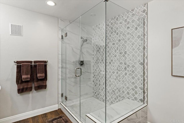 bathroom featuring baseboards, a shower stall, recessed lighting, and wood finished floors