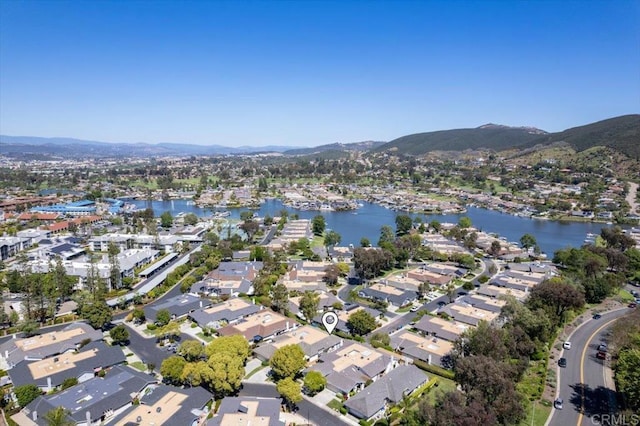 aerial overview of property's location with a water and mountain view and nearby suburban area