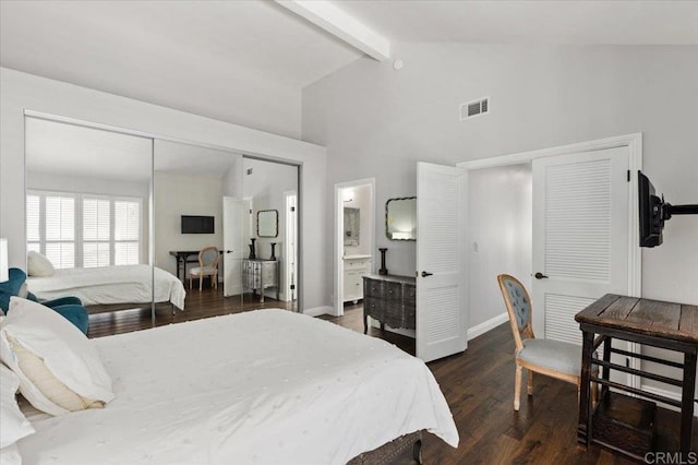 bedroom with beam ceiling, wood finished floors, baseboards, high vaulted ceiling, and ensuite bathroom