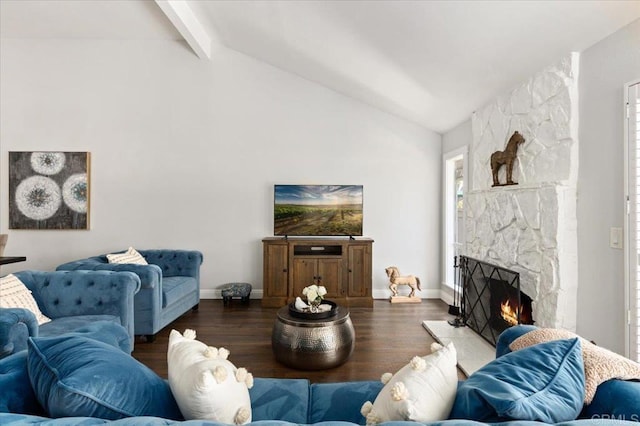 living area featuring beamed ceiling, a stone fireplace, wood finished floors, high vaulted ceiling, and baseboards