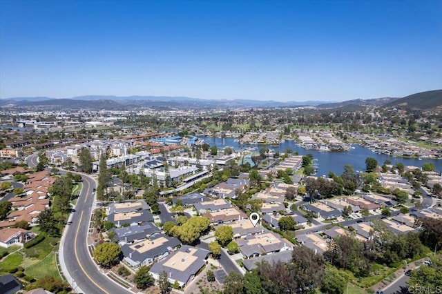 aerial view of property's location with nearby suburban area and a water and mountain view